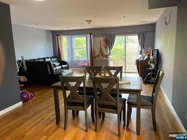 a dining room with furniture and wooden floor