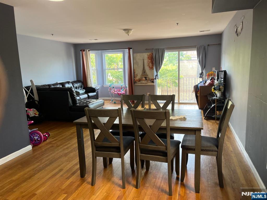 27-29 Camp Street Newark, NJ 07102 - Photo 13 of 24 a dining room with furniture and wooden floor