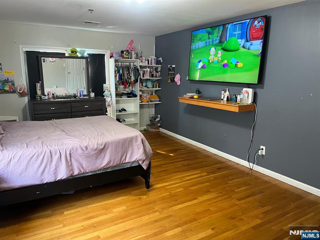 27-29 Camp Street Newark, NJ 07102 - Photo 15 of 24 a bedroom with bed and a flat screen tv