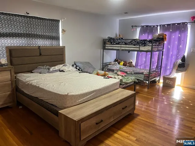 a bed sitting in a bedroom next to a window