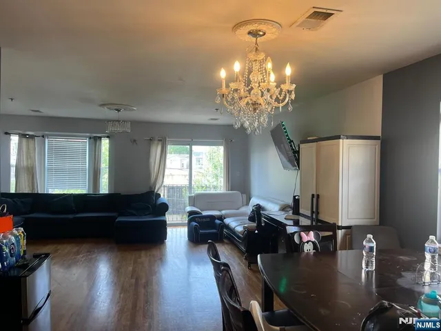 a living room with furniture and a chandelier