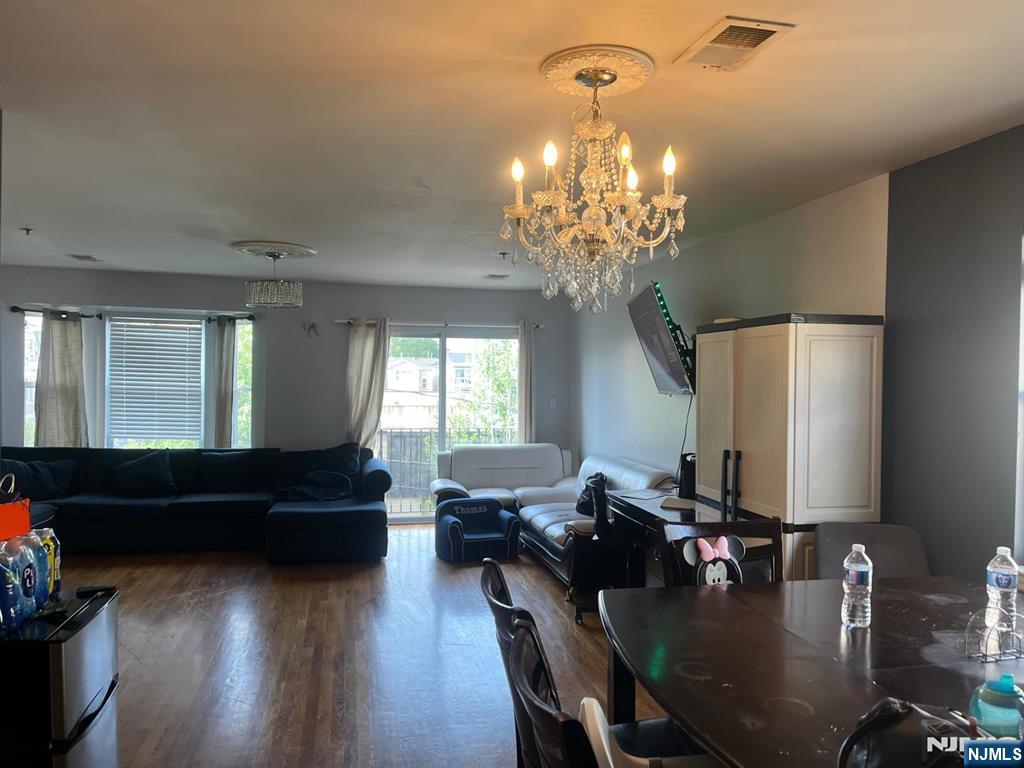 27-29 Camp Street Newark, NJ 07102 - Photo 17 of 24 a living room with furniture and a chandelier