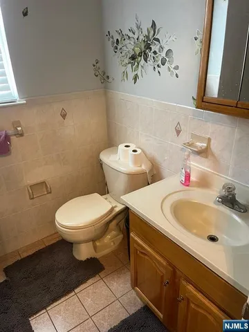 a bathroom with a sink mirror and toilet