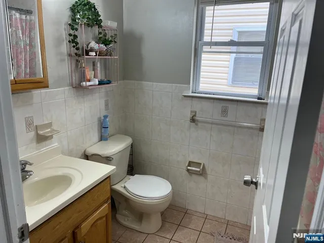 a bathroom with a sink toilet and window