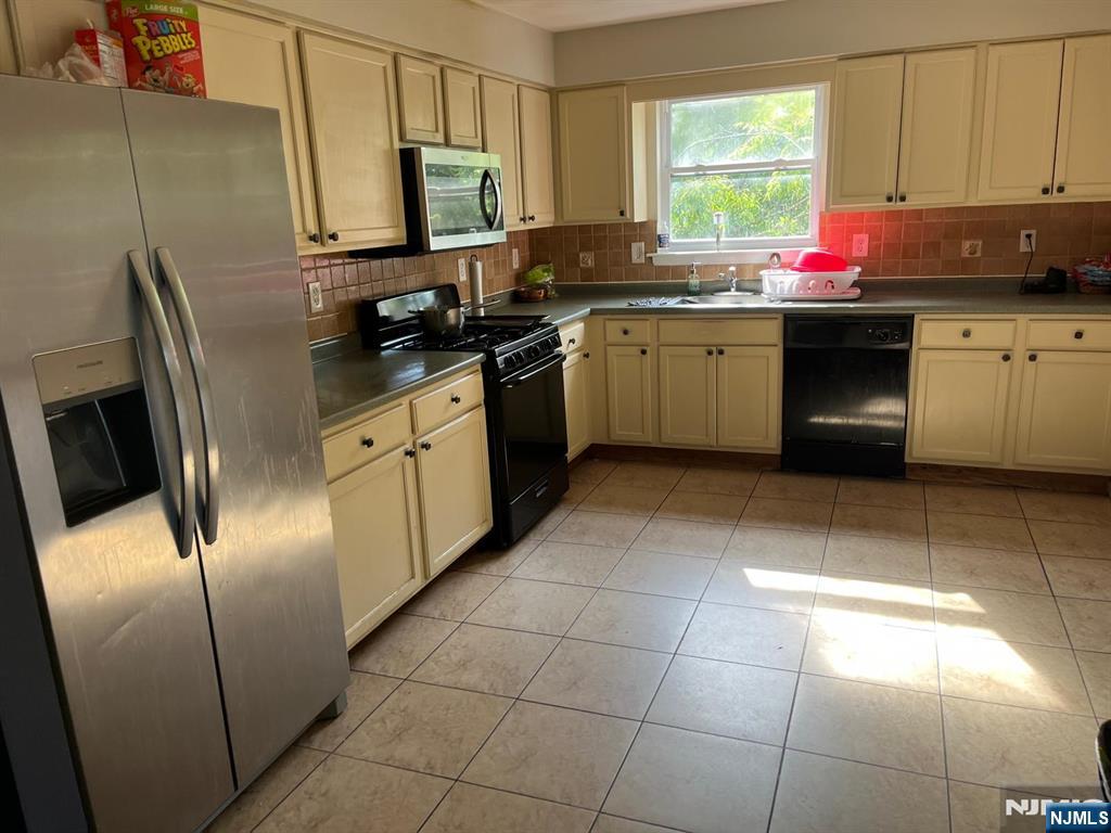 27-29 Camp Street Newark, NJ 07102 - Photo 24 of 24 a kitchen with stainless steel appliances a sink a stove a microwave a sink and cabinets