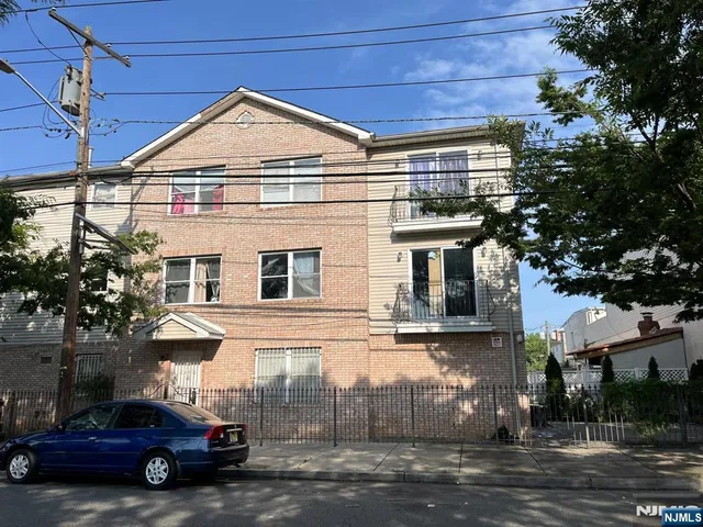 a front view of a house with parking