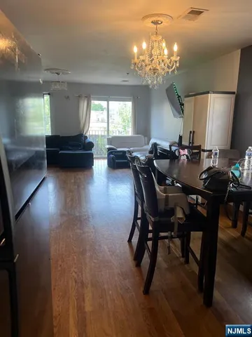 a view of a dining room with furniture and chandelier