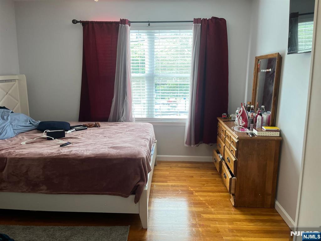 27-29 Camp Street Newark, NJ 07102 - Photo 9 of 24 a bedroom with a bed and flat screen tv