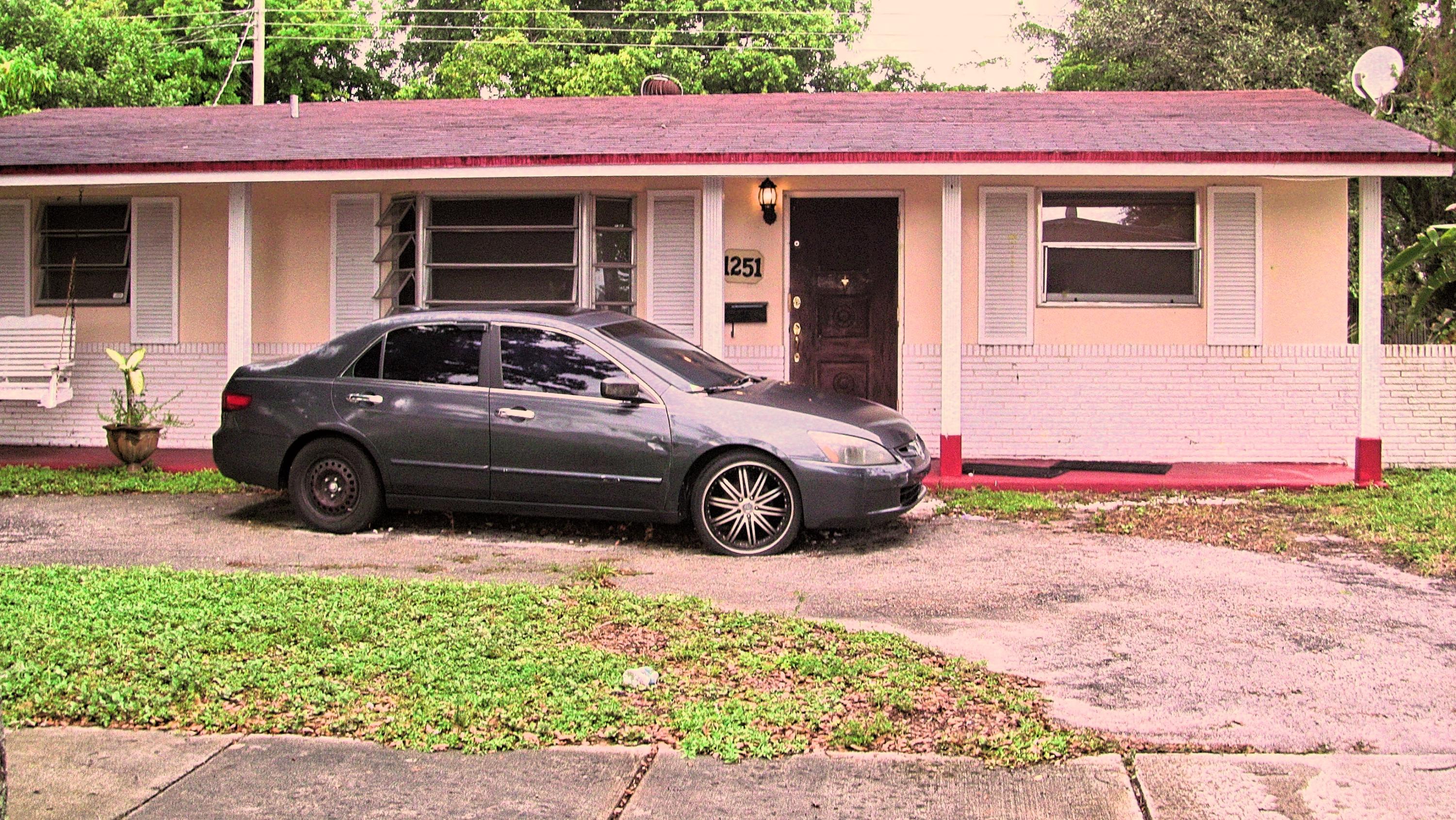 a view of a car parked in front of a house