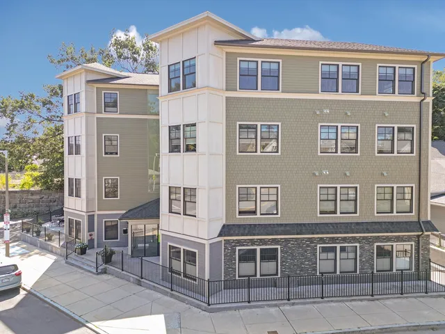 a front view of a building with a lot of windows