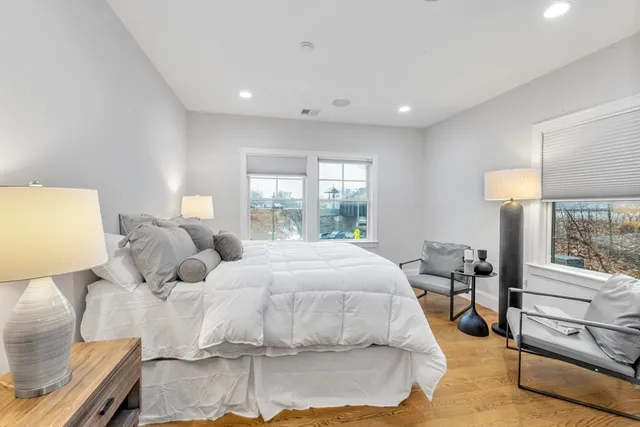 a bedroom with a bed and a night stand