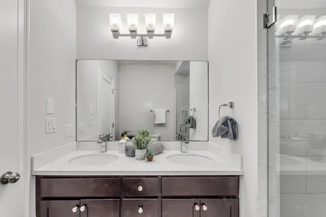 a bathroom with a sink vanity and a mirror