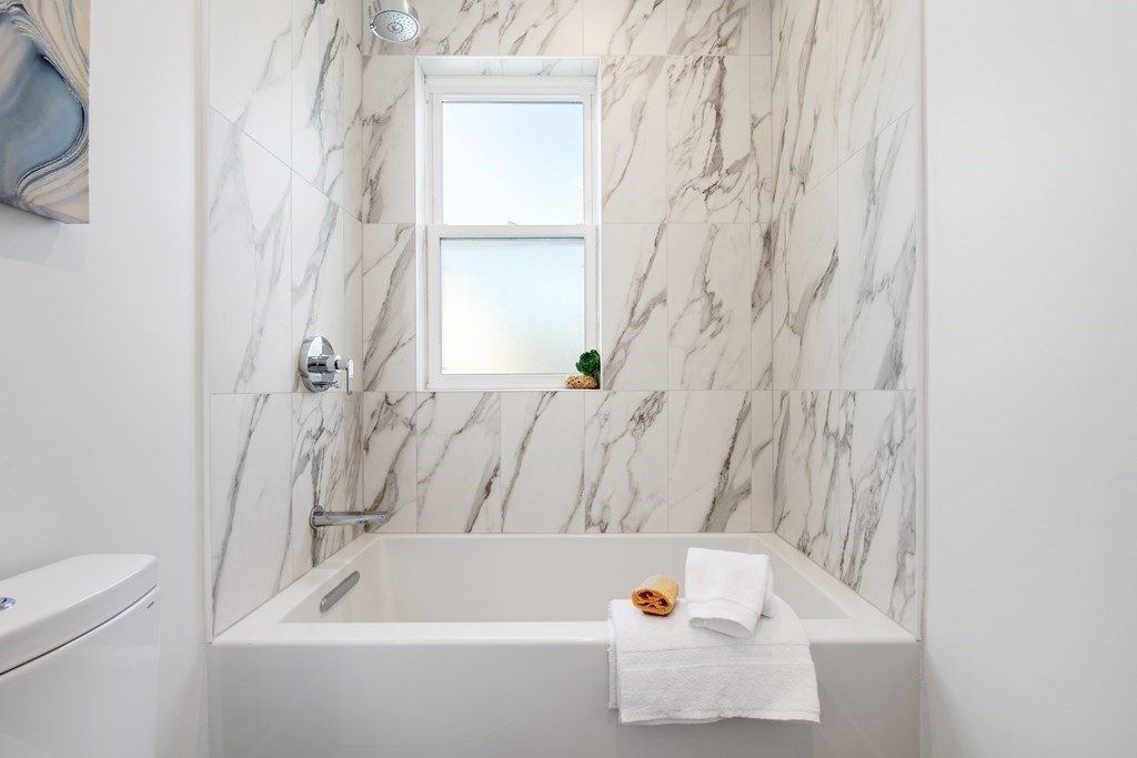 50 Whitfield Road, Unit 50 Somerville, MA 02144 - Photo 24 of 38 a bathroom with a bathtub