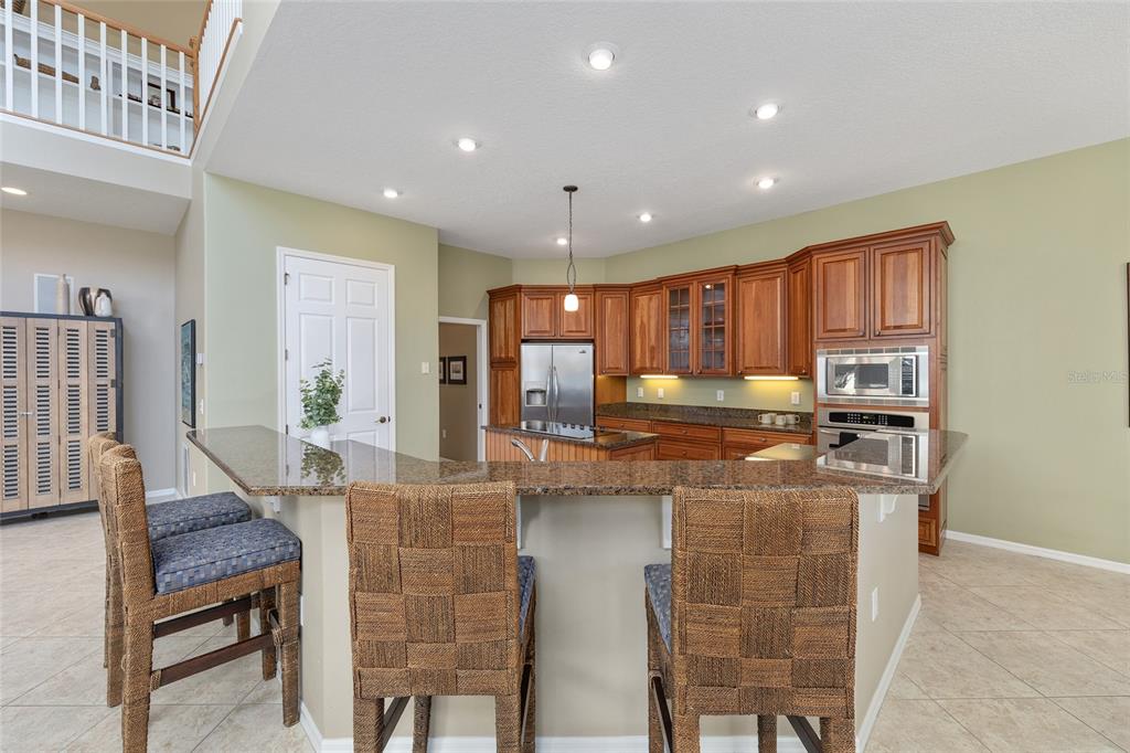 11944 West Creekside Lane Homosassa, FL 34448 - Photo 21 of 90 a kitchen with kitchen island counter top space cabinets and stainless steel appliances