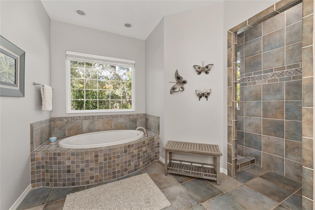 11944 West Creekside Lane Homosassa, FL 34448 - Photo 31 of 90 a bathroom with a tub a window and a shower