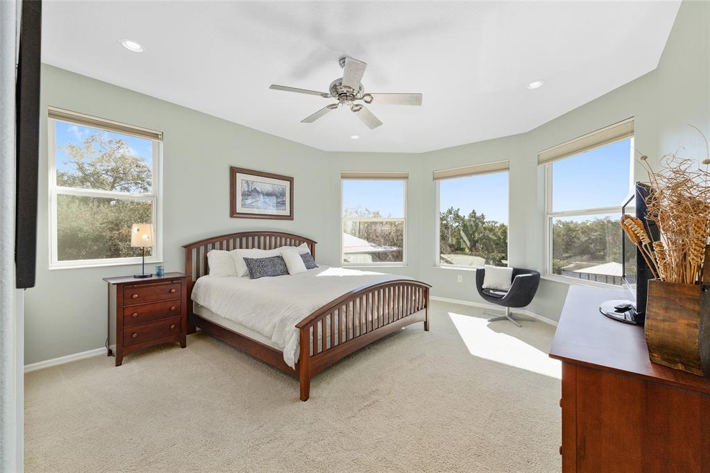 11944 West Creekside Lane Homosassa, FL 34448 - Photo 41 of 90 a spacious bedroom with a bed a flat screen tv and a large window