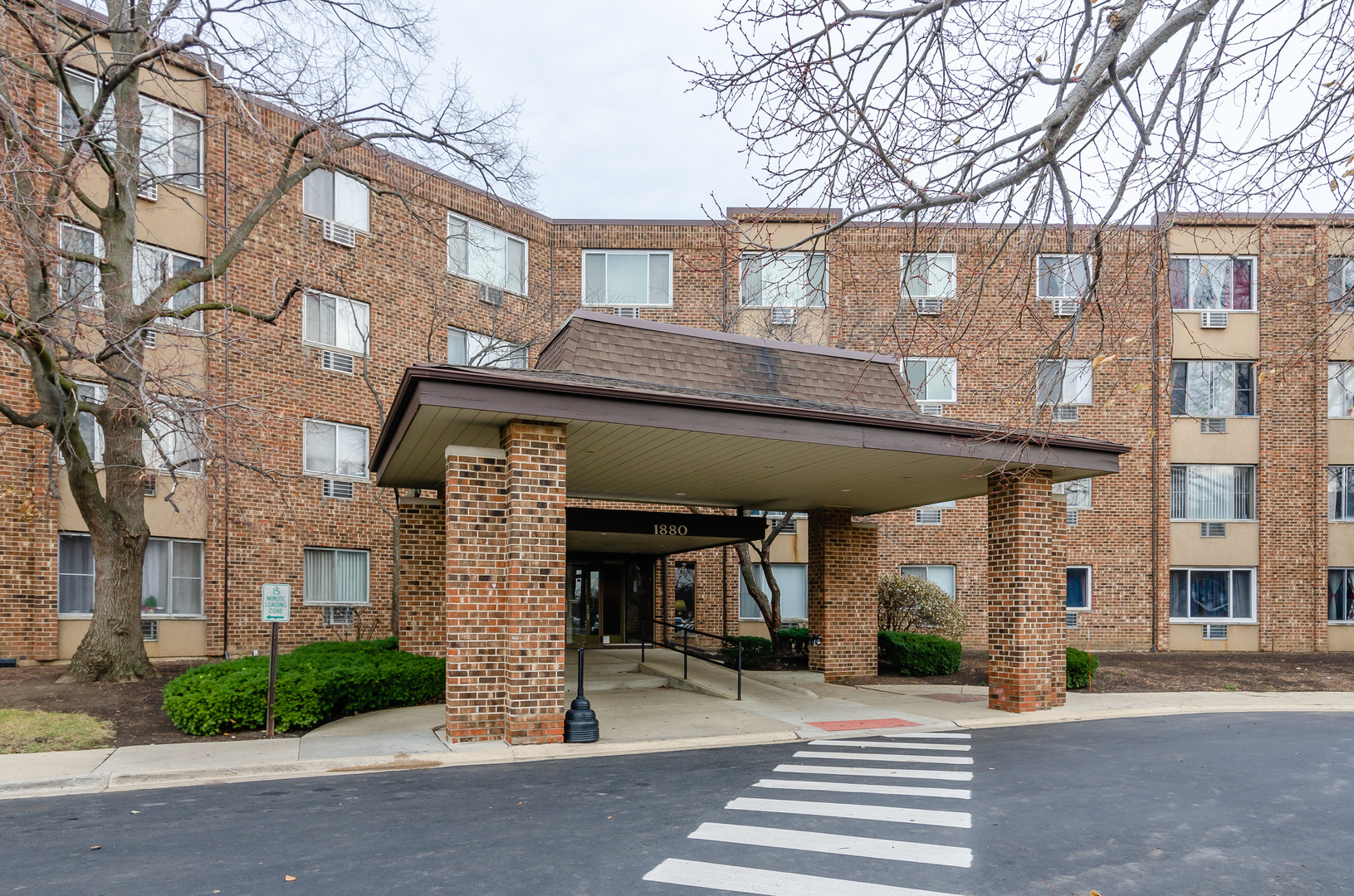 1880 Bonnie Lane, Unit 417 Hoffman Estates, IL 60169 - Photo 1 of 14 a front view of a building and car parked