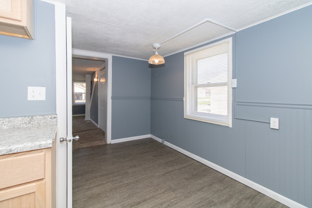120 North Coolidge Street Normal, IL 61761 - Photo 10 of 21 an empty room with wooden floor and windows