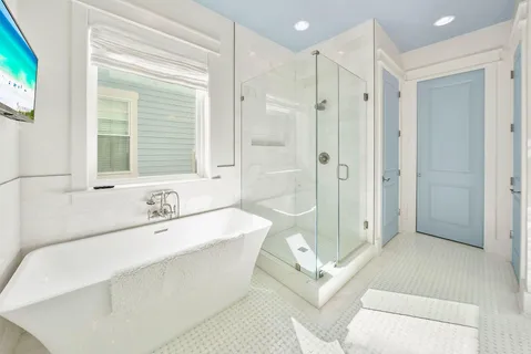 a spacious bathroom with a tub shower sink and mirror