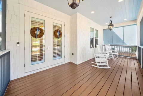 a view of a livingroom with furniture wooden floor and chandelier