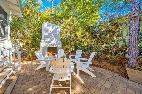 a view of a chairs and table in backyard