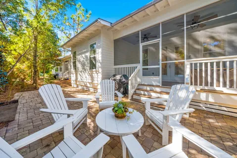 a view of a patio with couches chairs and a potted plant