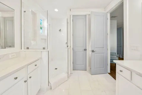 a bathroom with a sink vanity tub and a mirror