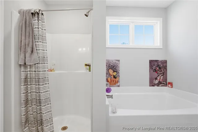 a en suite bathroom with a sink double vanity and a mirror