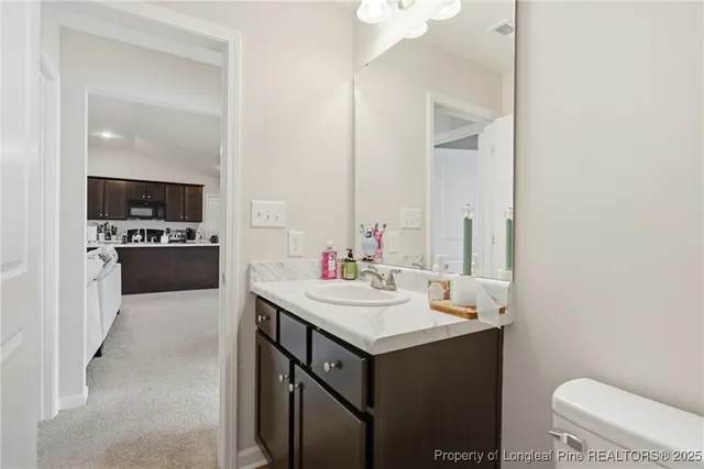 a utility room with a sink and a mirror