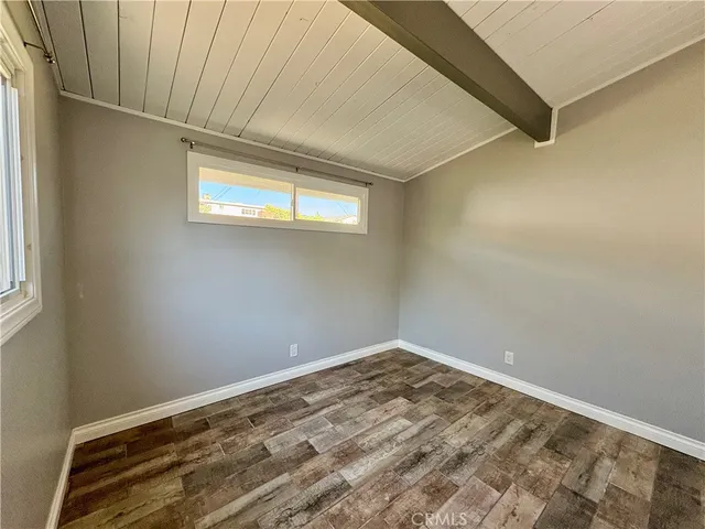 a view of a room with a white wall and a window