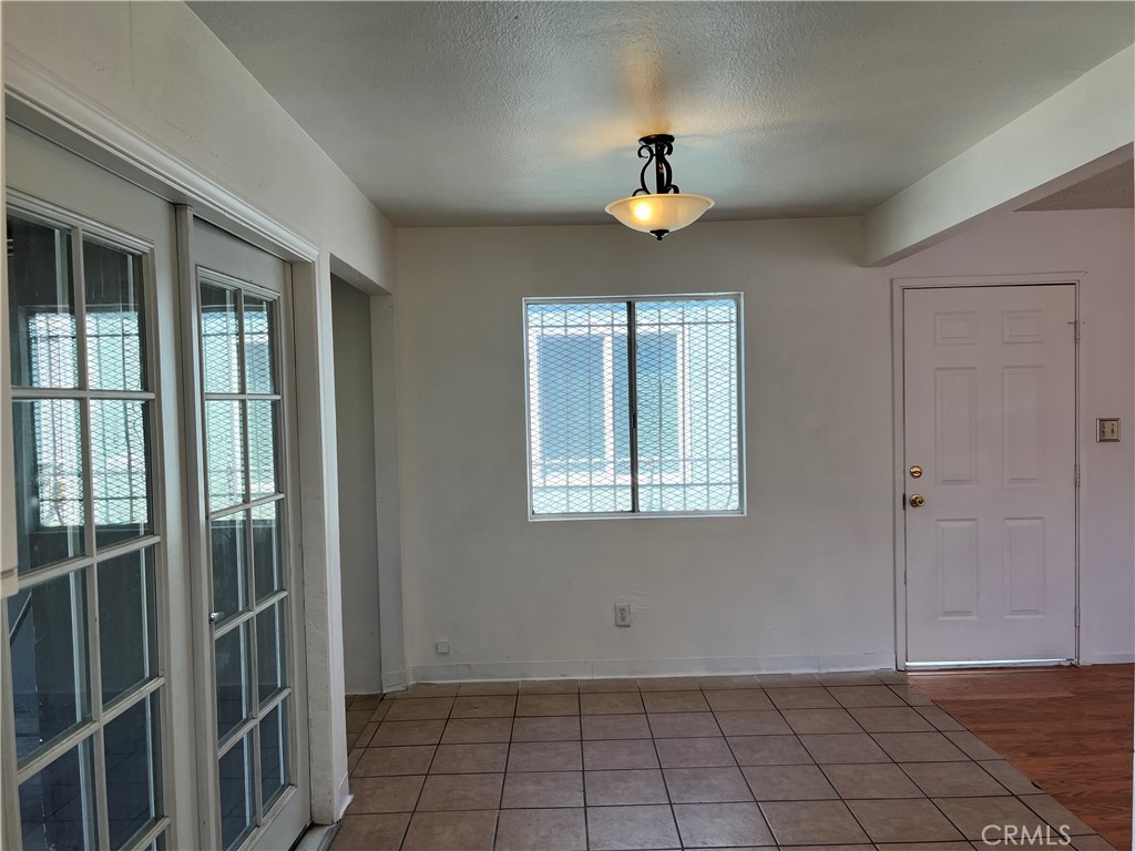 2519 East El Segundo Boulevard Compton, CA 90222 - Photo 3 of 10 a view of an empty room with window and chandelier fan
