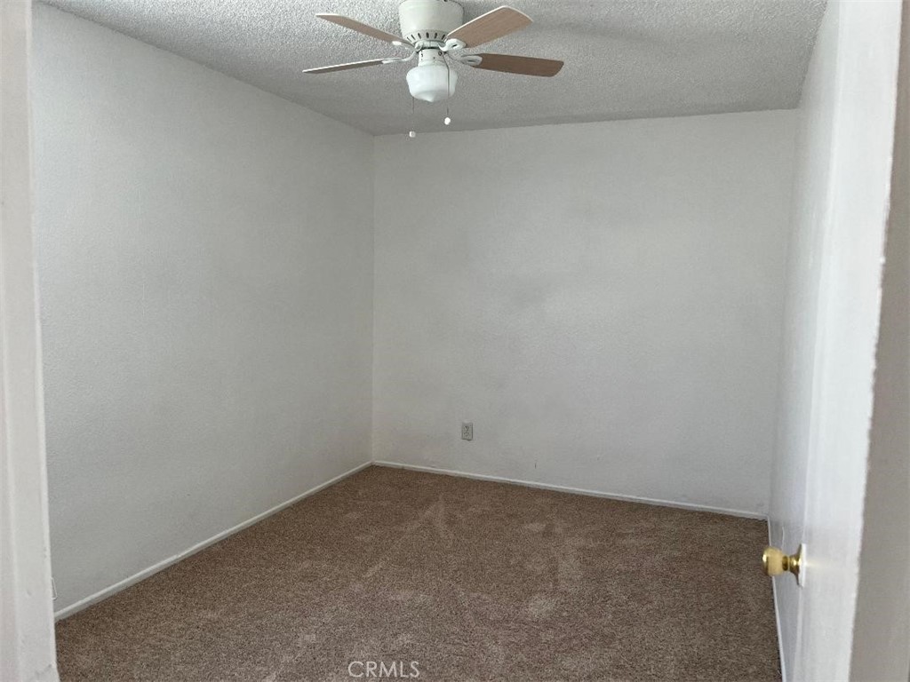 2519 East El Segundo Boulevard Compton, CA 90222 - Photo 9 of 10 an empty room with a fan & a window