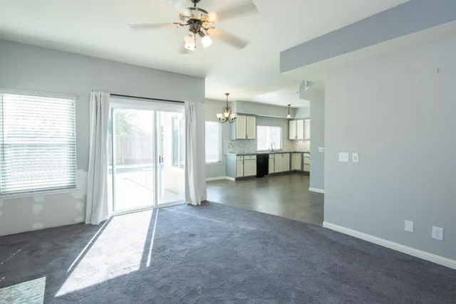 a view of empty room with a fireplace and fan