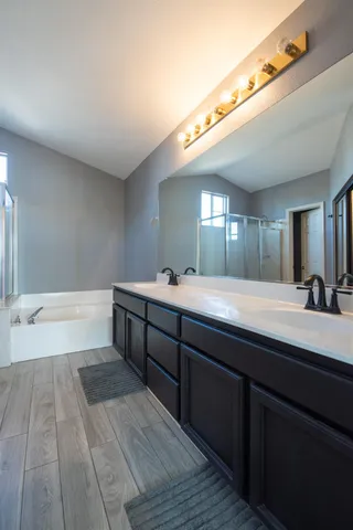 a spacious bathroom with a double vanity sink and a mirror