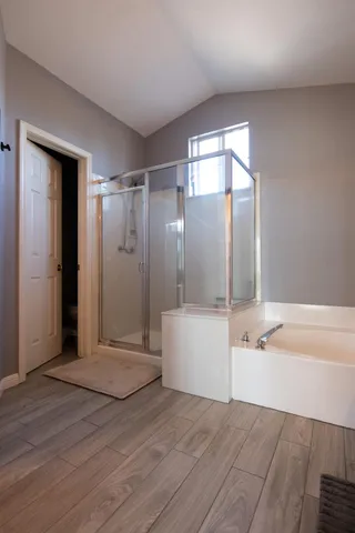 a bathroom with a bathtub a toilet and a shower