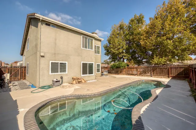a swimming pool with outdoor seating and yard