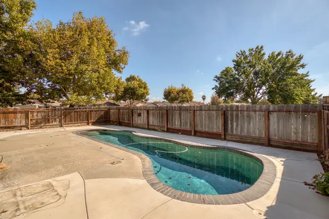 a view of a backyard with wooden fence