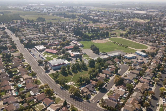 an aerial view of residential houses with city view