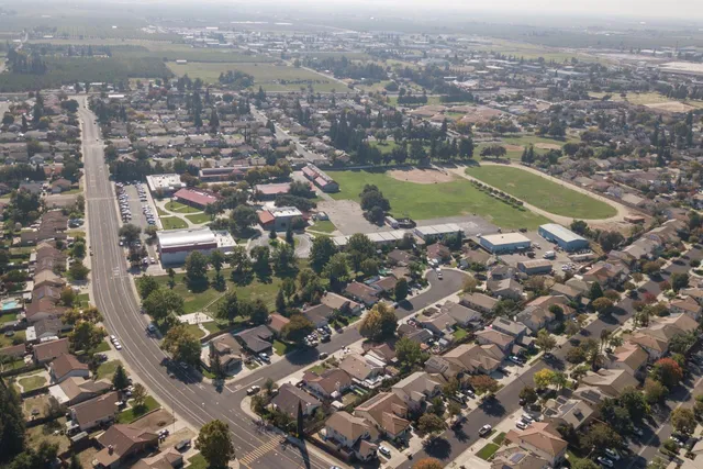 an aerial view of residential houses with city view