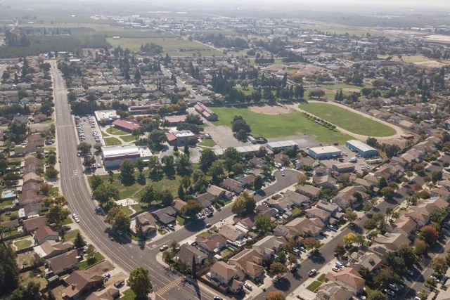 an aerial view of residential houses with outdoor space