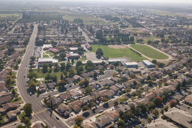 an aerial view of residential houses with city view