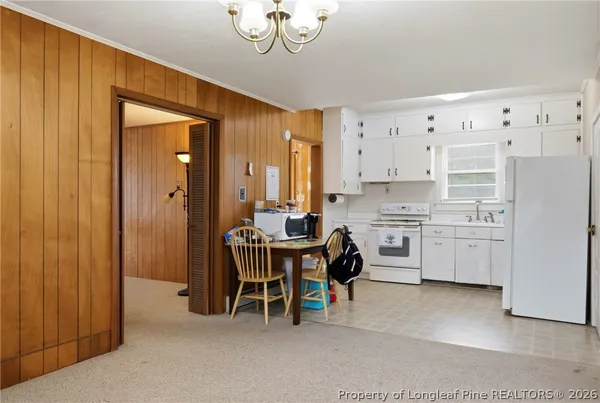 a kitchen with refrigerator cabinets and wooden floor