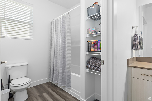 4735 Alder Drive, Unit F101 Mapleton, UT 84664 - Photo 18 of 30 Bathroom featuring dark wood finished floors, vanity, and shower / bath combination with curtain