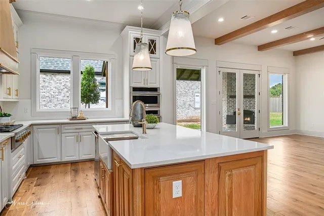 a kitchen with a sink a counter space and cabinets