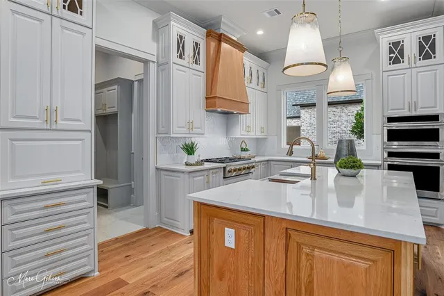 a kitchen with stove and cabinets