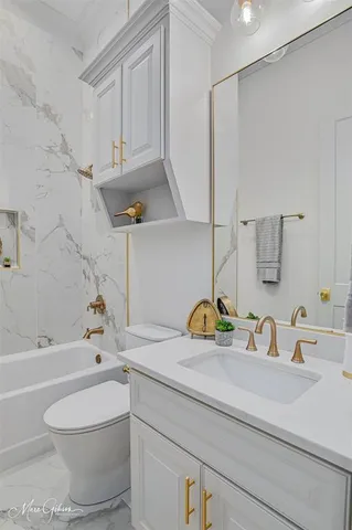 a bedroom with a large bed and a night stand