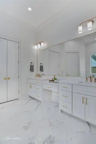 a spacious bathroom with a sink and a mirror