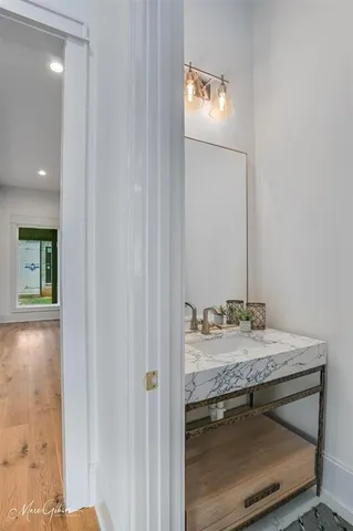 a view of empty room with wooden floor a fireplace