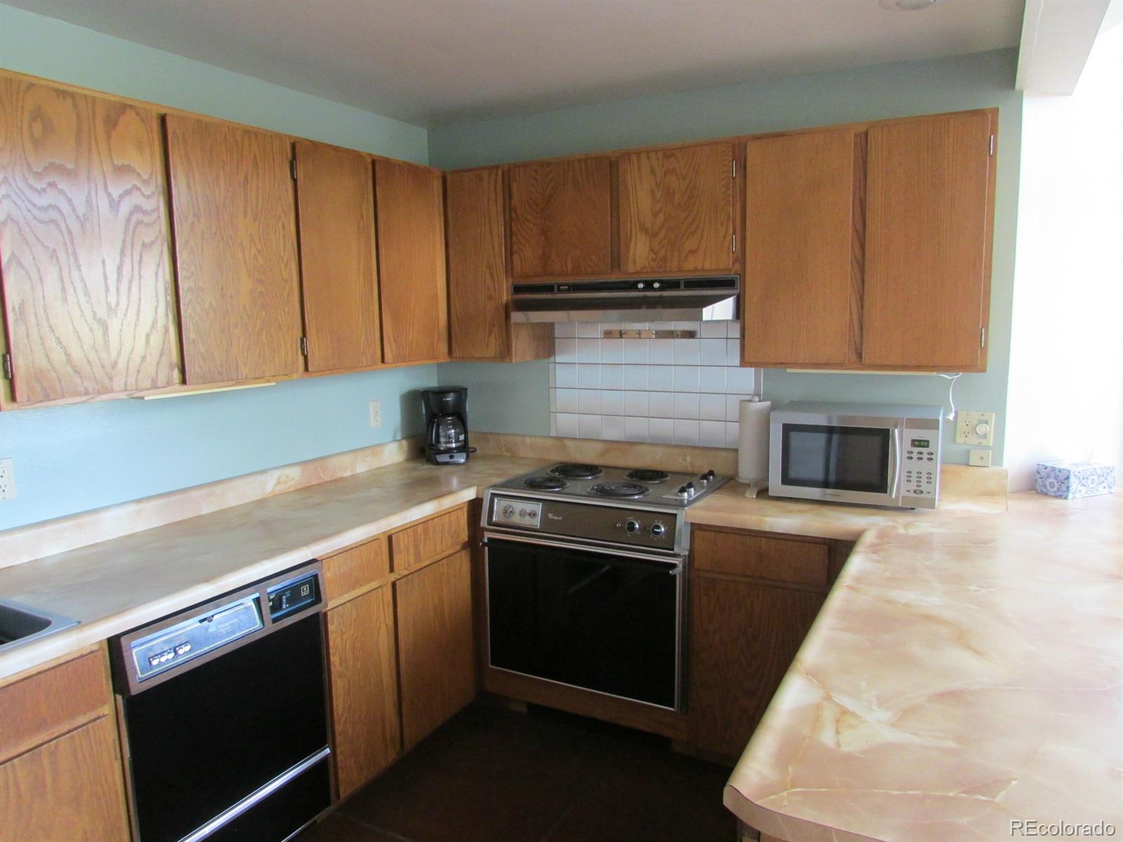5410 Hunt Place Rye, CO 81069 - Photo 8 of 22 a kitchen with wooden cabinets and a stove top oven