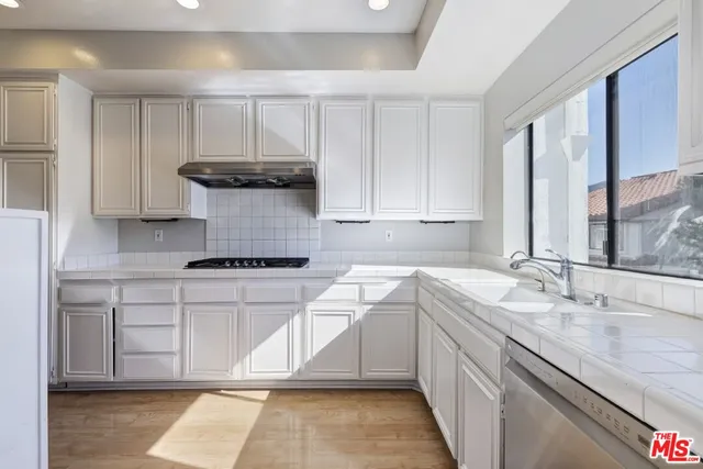 a kitchen with a sink stove and cabinets